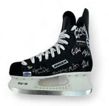 A black and white Bauer hockey skate from Sports Integrity, labeled "1980 USA Miracle On Ice 22 Signed Bauer Hockey Skates Herb Brooks & More BAS LOA," featuring multiple white autographs and TUUK branding on the silver blade holder.