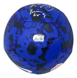 The 1999 USA Soccer Women's Team Signed Blue Nike Soccer Ball by Sports Integrity features a blue and black camo pattern, white autographs, a barcode sticker on one panel, and a small red and white striped section. Comes with BAS ITP and case.