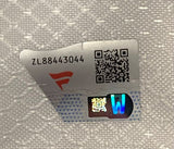 A close-up of a tamper-evident sticker on the 2016 Curtis Cup USGA Event Issued Golf Flag by Sports Integrity, showing code ZL88443044, a QR code, red and grey logo, and holographic W on textured white background.