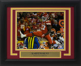 The Sports Integrity Kareem Hunt Framed 8x10 Kansas City Chiefs Photo features Hunt (#27) leaping over an opponent during a game, complete with a nameplate beneath the image.