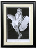 The Sports Integrity Marilyn Monroe Framed 16x23 The Seven Year Itch Hulton Archive Giclee features the iconic black-and-white image of Monroe in a white dress over a subway grate, smiling as her skirt billows, matted and set in a black frame.