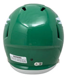The Saquon Barkley Signed Full Size Kelly Green Replica Speed Helmet by Sports Integrity features side ventilation slits, a white warning label on the back, and a small round sticker near the bottom.