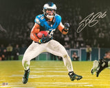 Saquon Barkley is shown in a blue and white Philadelphia Eagles uniform running with the ball and dodging a defender on the field, with his autograph in the top right corner. This is a Sports Integrity 16x20 signed photo, BAS ITP authenticated.