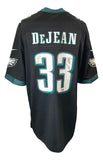A Cooper DeJean signed Philadelphia Eagles Nike Game Jersey by Sports Integrity, featuring black fabric with teal and white details, DeJEAN and #33 on the back, and a signature in black ink.