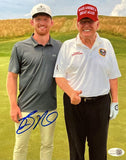 In this Sports Integrity 8x10 photo, Bo Nickal poses on a golf course with Donald Trump, who is in a red MAGA hat, white shirt, and dark pants. Nickal wears a gray polo and khaki pants. The photo features Bo Nickal's autograph.