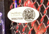 A white oval sticker with a signature, QR code, and code WB827508 is attached to a Sports Integrity Bo Nickal Signed 11x14 UFC Photo (JSA ITP), with a red and black mesh pattern in the background.