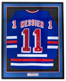 The Sports Integrity Mark Messier New York Signed Framed Blue Hockey Jersey (JSA) features blue fabric with red and white stripes, Messier’s name and number 11, his signature on the number, all displayed against a dark background.