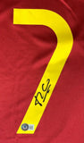 A Luis Figo Signed Portugal Nike Soccer Jersey by Sports Integrity features a large yellow number 7 on red fabric with a black autograph and a BAS QR code sticker at the bottom left.