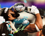 Brandon Graham kisses the Lombardi Trophy in this signed 11x14 photo (Sports Integrity), celebrating the Eagles' SB52 win with teal and white confetti and a bold green autograph visible. JSA authenticated.