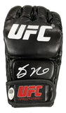 The Sports Integrity Bo Nickal Signed In White UFC Fight Glove (JSA ITP) features a black design, white UFC logo on top, Bo Nickal's white signature on the knuckle area, and a red UFC logo with slogan on the wrist strap.