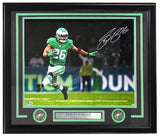 The Sports Integrity Saquon Barkley Signed Framed 16x20 Eagles Kelly Green Photo (BAS ITP) features Barkley running on the field, a name plaque, and two commemorative coins displayed beneath the autographed image.