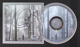 The Sports Integrity T Swift Signed Framed Folklore CD Booklet includes an autographed cover, PSA/DNA authentication, and an 11x14 misty forest photo with tall trees and a solitary figure.