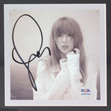 The T Swift Framed Swift Eras Tour Shirt with Signed Insert by Sports Integrity features a PSA/DNA authenticated autograph from Taylor Swift, beautifully displayed in a frame for collectors and fans.