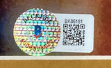 A holographic sticker with a blue R logo and text sits beside a white label showing BK86181 and a QR code on the framed Joe Montana Signed 16x20 San Francisco 49ers Back Photo by Sports Integrity.