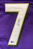 A Rashod Bateman Baltimore Signed Purple Football Jersey by Sports Integrity features a large white #7 with black and gold trim, a black marker signature, and two authentication stickers at the bottom left.