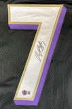 The Rashod Bateman Baltimore Signed Black Football Jersey by Sports Integrity features a white number 7 with gold and purple borders sewn on black mesh, signed in black ink with a BAS authentication sticker at the bottom.