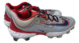 A pair of Paul Goldschmidt Twice Signed 2023 Game Used Cardinals Nike Cleats by Sports Integrity, featuring gray uppers with red and navy accents, white midsoles, molded plastic spikes, mesh uppers, lace closures, and a Nike swoosh.