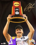 A smiling player in LSU gear celebrates with a 2023 National Champion trophy in this signed 16x20 photo by Paul Skenes. Features MLB Hologram. Available from Sports Integrity.