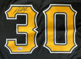 The Paul Skenes Signed Pittsburgh Pirates Black Nike Replica Jersey by Sports Integrity features a large gold-trimmed number 30, a black marker signature on the upper left, and two authentication stickers on the lower left of the "3.