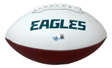 A white and brown Sports Integrity football with "EAGLES" in green on the white panel, signed by Jalen Carter, features a small authentication sticker below the text. This is a Philadelphia Eagles logo football authenticated by BAS.
