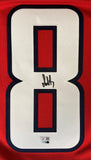 A close-up of a red Washington Capitals jersey by Sports Integrity, featuring Alexander Ovechkin’s black autograph across the large white number 8 outlined in navy blue.