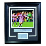 The Sports Integrity Lionel Messi Framed 8x10 Inter Miami 1st Goal Photo features Messi celebrating in pink, with a nameplate and laser-engraved signature, all presented in a sleek black frame.