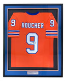 A custom Adam Sandler "The Waterboy" Boucher football jersey, signed and framed by Sports Integrity, features orange fabric with white and blue stripes, name BOOUCHER, number 9, and a plaque reading ADAM SANDLER. Certified by JSA Holo.