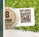 A rectangular sticker with QR code, serial 2W738802, and Beckett hologram is on a Sports Integrity AJ Brown Signed Framed 16x20 Philadelphia Eagles Super Bowl 59 LIX Photo, against a blurred green background.