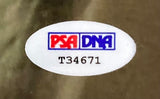 A close-up of the PSA/DNA logo sticker with serial T34671 on a Sports Integrity Al Pacino Signed Framed 11x14 Scarface Photo.