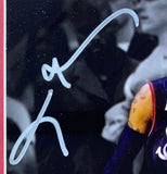 A close-up 8x10 photo of Allen Iverson's right shoulder in uniform, with a large light blue autograph. The blurred background shows part of the audience. Sports Integrity. Signed, framed; Philadelphia 76ers Lue Step Over Photo (JSA ITP).