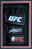 A Sports Integrity Amanda Nunes signed black UFC glove with white signature and certification, plus an 8x10 Rousey photo, displayed in a black and red shadowbox frame.