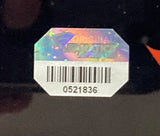 A holographic Sports Integrity sticker with a barcode and the number 0521836, featuring shiny colors and partial text, is included on the Archie Griffin Signed Framed 20x24 Ohio State Photo w/ 4 Inscriptions by Fanatics.