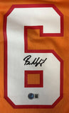 The Baker Mayfield Signed Tampa Bay Buccaneers Orange Nike Game Replica Jersey by Sports Integrity features a white number 6 with red outline on orange fabric, black autograph on the number, and a round QR authentication sticker below.