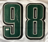 Close-up of a Jalen Carter Philadelphia Signed White Football Jersey by Sports Integrity, featuring number 98 outlined in black and silver with a signature on the 9 and an authentication sticker near the bottom left.