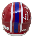The Sports Integrity Jim Kelly Thomas Reed Signed Bills FS Replica Speed Helmet features autographs on top, red shell with white and blue center stripes, and a warning label on the lower left side.