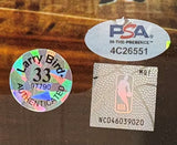 The Larry Bird Signed Framed 8x10 Boston Celtics vs Lakers Photo by Sports Integrity includes a holographic Larry Bird AUTHENTICATED 33 97790 sticker, a silver oval PSA IN-THE-PRESENCE 4C26551 sticker, and a square silver NBA logo NC046039020 sticker.