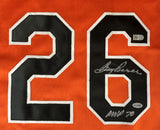 The Boog Powell Baltimore Signed Orange Baseball Jersey by Sports Integrity features the number 26 in black with white trim, two silver autographs on the digits, and two authentication stickers.