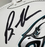 A close-up of a Brandon Graham autographed Eagles logo football by Sports Integrity, featuring his signature above the stylized eagle eye and beak, with JSA authentication and Super Bowl 59 LIX case.