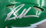 A close-up of a Brandon Graham signed Eagles Kelly Green mini helmet by Sports Integrity, featuring bold white autograph, ventilation holes, part of a white design at the bottom edge, and JSA authentication with Super Bowl 59 LIX case.