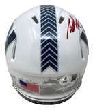 The Brian Robinson Jr Signed Commanders Salute To Service Mini Speed Helmet by Sports Integrity features a white shell, dark chevron stripe, red autograph, American flag, digital camo at the back, and BAS certification sticker.