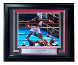 The Sports Integrity Buster Douglas Signed Framed 8x10 Photo shows Douglas standing over Mike Tyson after his knockout on February 11, 1990, at Tokyo Dome. Includes PSA/DNA authentication and commemorative plaque.