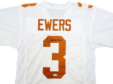 The Sports Integrity Quinn Ewers Texas Signed White Football Jersey BAS features burnt orange accents, the name EWERS and number 3, with Ewers’ autograph in black marker on the number.