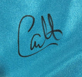 A black autograph-style "Catt" signature appears on shiny blue fabric of Sports Integrity’s Carlito Signed Custom Wrestling Shorts, authenticated by a JSA QR hologram.