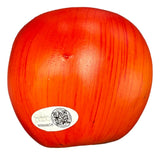 A Carlito Signed WWE Plastic Prop Apple by Sports Integrity features a shiny red surface with faint vertical lines and a small oval JSA QR hologram sticker with text near the bottom.