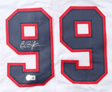 Close-up of a Charlie Sheen Major League Signed White Rick Vaughn Baseball Jersey by Sports Integrity, showing the number 99 in dark blue with red outline, a silver autograph on the left digit, and an authentication sticker at the bottom.