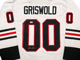 A white “GRISWOLD 00” hockey jersey from Sports Integrity, featuring black and red trim. The left zero is signed by Chevy Chase. From Lampoon’s Christmas Vacation; BAS certified.