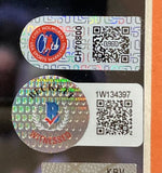 Close-up of two holographic authentication stickers with QR codes, serial numbers, and logos on a flat surface. The upper sticker reads Chet Holmgren Sports Marketing for a Sports Integrity Chet Holmgren Signed Framed 16x20 OKC Thunder Photo BAS.