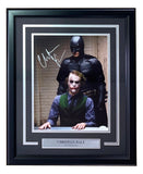 The Sports Integrity Christian Bale Signed Framed 11x14 The Dark Knight Photo w/ Heath Ledger (JSA) features Batman standing behind the Joker at a table, with a plaque reading "Christian Bale, The Dark Knight.