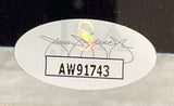 White oval sticker with black code AW91743, a holographic S, and a gray signature above the code on the Christian Bale Signed Framed 11x14 The Dark Knight Photo w/ Heath Ledger by Sports Integrity.