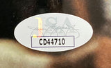 A white oval sticker with the JSA authentication logo and bold black code CD44710 is affixed to the Christopher Walken Signed Framed 8x10 Last Man Standing Photo by Sports Integrity.